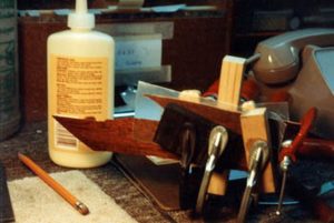 Gluing the separated pieces of the mahogany top