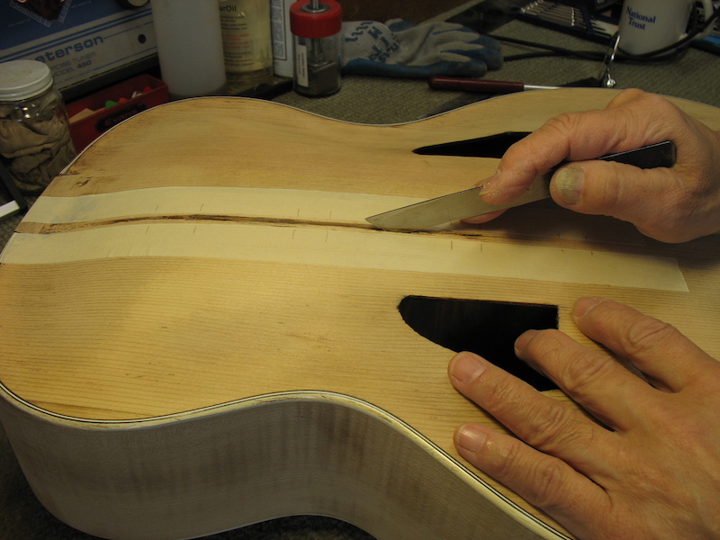 Cleaning up and smoothing the crack on the archtop guitar
