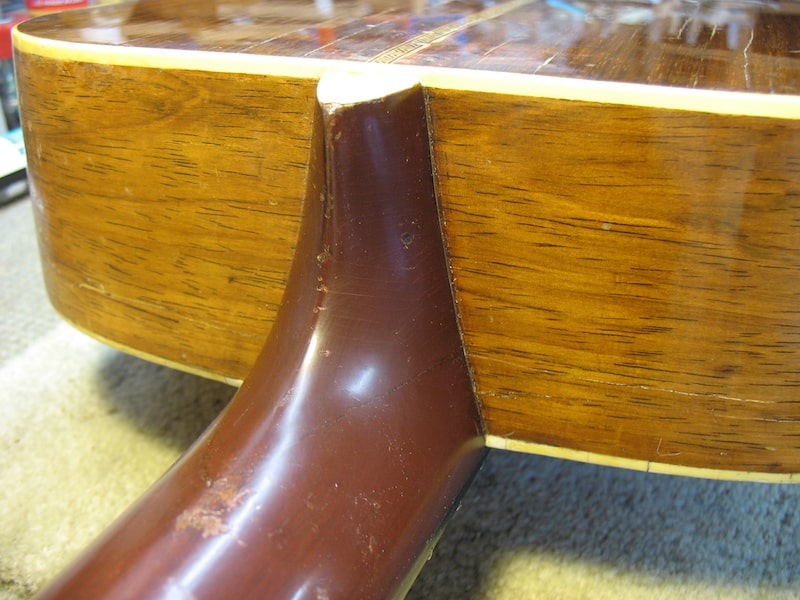 The repaired heel of the vintage parlor guitar
